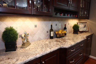 Example of a trendy kitchen design in DC Metro with glass-front cabinets, granite countertops and dark wood cabinets