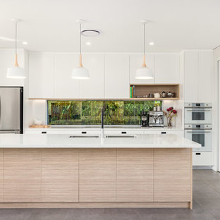 Inspiration for a small contemporary galley eat-in kitchen in Sydney with an undermount sink, flat-panel cabinets, white cabinets, window splashback, white appliances, with island, white benchtop, quartz benchtops, porcelain floors and grey floor.