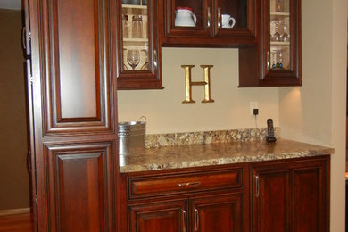 Example of a mid-sized classic single-wall medium tone wood floor and beige floor kitchen design in Cedar Rapids with raised-panel cabinets, medium tone wood cabinets, granite countertops and no island