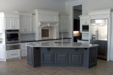 Example of a kitchen design in Toronto with an undermount sink, stainless steel appliances and an island