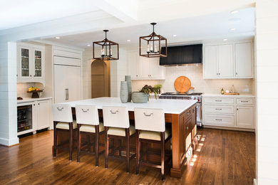 Transitional medium tone wood floor open concept kitchen photo in Atlanta with beaded inset cabinets, white cabinets, ceramic backsplash and an island