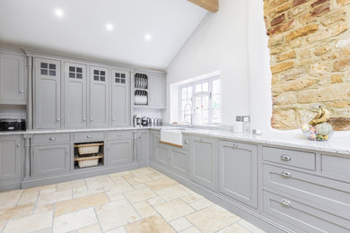 Design ideas for a medium sized traditional u-shaped kitchen/diner in Other with a belfast sink, beaded cabinets, medium wood cabinets, granite worktops, black appliances, marble flooring, yellow floors and multicoloured worktops.
