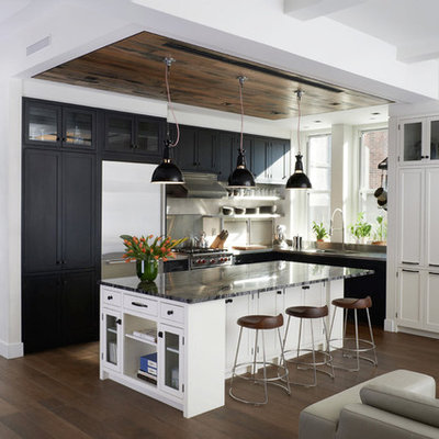 Large transitional l-shaped medium tone wood floor open concept kitchen photo in New York with shaker cabinets, black cabinets, quartzite countertops, stainless steel appliances, an integrated sink, white backsplash, ceramic backsplash and an island