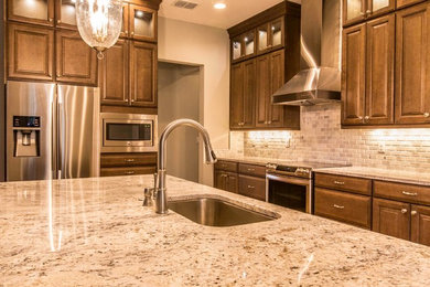 Inspiration for a large contemporary l-shaped ceramic tile open concept kitchen remodel in Tampa with an undermount sink, gray backsplash, porcelain backsplash, stainless steel appliances and an island