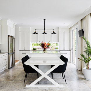 Inspiration for a large transitional l-shaped open plan kitchen in Sydney with white cabinets, quartz benchtops, white splashback, ceramic splashback, stainless steel appliances, with island, travertine floors, grey floor, shaker cabinets and grey benchtop.