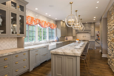Enclosed kitchen - traditional l-shaped dark wood floor and brown floor enclosed kitchen idea in Cincinnati with recessed-panel cabinets, stainless steel appliances, a farmhouse sink, gray cabinets, white backsplash, mosaic tile backsplash, an island and gray countertops