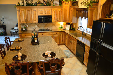 Eat-in kitchen - mid-sized traditional l-shaped ceramic tile eat-in kitchen idea in Albuquerque with an undermount sink, raised-panel cabinets, distressed cabinets, granite countertops, beige backsplash, ceramic backsplash, colored appliances and an island