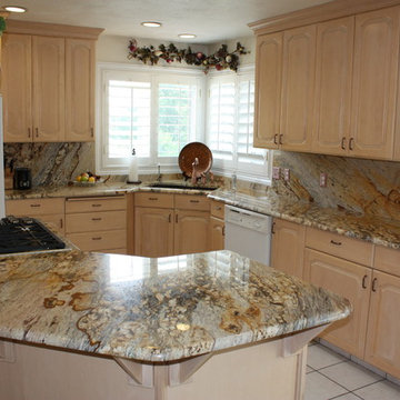 Granite kitchen with large island and full granite backsplash