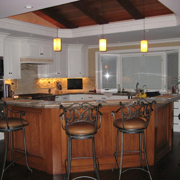 granite, painted cabinets with stained island, vaulted ceiling with false beams
