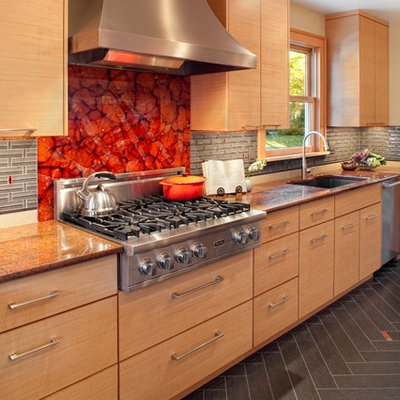 Large trendy galley porcelain tile eat-in kitchen photo in Portland with granite countertops, an undermount sink, flat-panel cabinets, gray backsplash, glass tile backsplash, stainless steel appliances and light wood cabinets