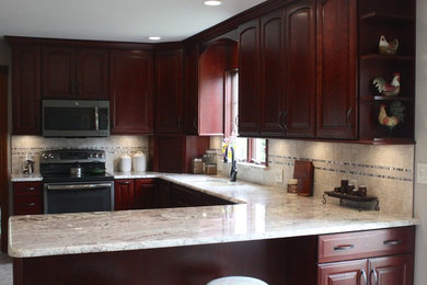 Mid-sized elegant u-shaped eat-in kitchen photo in Other with raised-panel cabinets, medium tone wood cabinets, granite countertops, beige backsplash and an island