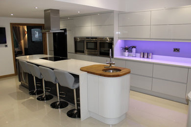 Inspiration for a modern kitchen in Other with grey cabinets, quartz worktops and an island.
