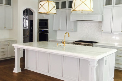Inspiration for a large timeless dark wood floor open concept kitchen remodel in Raleigh with a farmhouse sink, glass-front cabinets, gray cabinets, marble countertops, white backsplash, ceramic backsplash, paneled appliances and an island