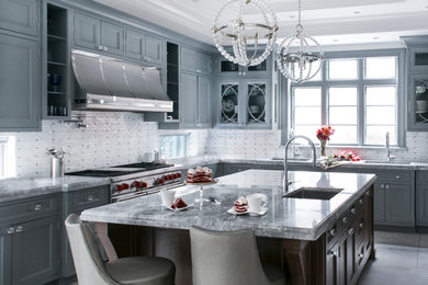 Inspiration for a huge transitional u-shaped porcelain tile eat-in kitchen remodel in New York with an undermount sink, recessed-panel cabinets, gray cabinets, quartzite countertops, multicolored backsplash, mosaic tile backsplash, stainless steel appliances and an island