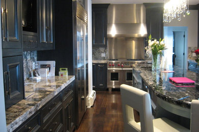 Example of a large transitional l-shaped dark wood floor eat-in kitchen design in Denver with an undermount sink, recessed-panel cabinets, dark wood cabinets, marble countertops, multicolored backsplash, metal backsplash, stainless steel appliances and an island