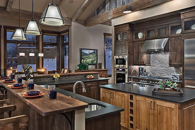 Open concept kitchen - large contemporary single-wall light wood floor open concept kitchen idea in Denver with a double-bowl sink, beaded inset cabinets, dark wood cabinets, quartz countertops, gray backsplash, matchstick tile backsplash, stainless steel appliances and an island
