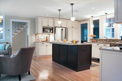 This is an example of a classic u-shaped kitchen/diner in Boston with white cabinets and an island.