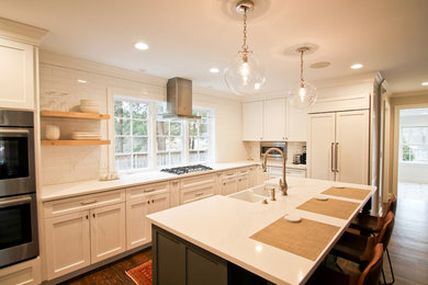 Example of a large farmhouse u-shaped eat-in kitchen design in Bridgeport with recessed-panel cabinets, white cabinets, quartzite countertops and an island