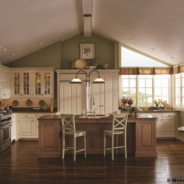Green and White Kitchen with Wood Island