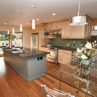 Inspiration for a large contemporary galley open plan kitchen in Seattle with an undermount sink, shaker cabinets, light wood cabinets, zinc benchtops, green splashback, ceramic splashback, stainless steel appliances, medium hardwood floors and with island.