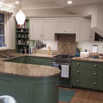 Green hand painted country kitchen with flat panel cabinets