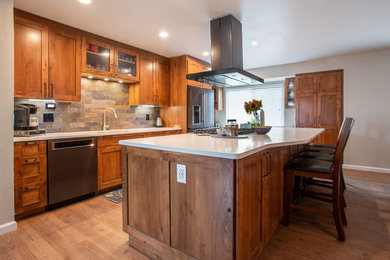 Inspiration for a large rustic l-shaped medium tone wood floor and brown floor eat-in kitchen remodel in Other with an undermount sink, shaker cabinets, brown cabinets, quartz countertops, multicolored backsplash, slate backsplash, stainless steel appliances, an island and white countertops