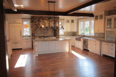 Example of a mid-sized classic u-shaped dark wood floor eat-in kitchen design in Cleveland with recessed-panel cabinets, white cabinets, granite countertops, beige backsplash, ceramic backsplash, stainless steel appliances and an island