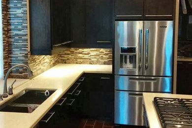 Inspiration for a mid-sized transitional u-shaped vinyl floor and brown floor kitchen remodel in Houston with flat-panel cabinets, dark wood cabinets, quartz countertops, brown backsplash, matchstick tile backsplash, stainless steel appliances, an island and white countertops