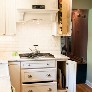 Small transitional enclosed kitchen designs - Enclosed kitchen - small transitional u-shaped medium tone wood floor enclosed kitchen idea in Milwaukee with a farmhouse sink, shaker cabinets, white cabinets, granite countertops, white backsplash, subway tile backsplash, stainless steel appliances and a peninsula
