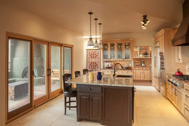Large elegant l-shaped ceramic tile and beige floor enclosed kitchen photo in Albuquerque with a farmhouse sink, raised-panel cabinets, light wood cabinets, granite countertops, beige backsplash, mosaic tile backsplash, paneled appliances and an island