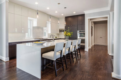 Open concept kitchen - contemporary l-shaped dark wood floor and brown floor open concept kitchen idea in Other with an undermount sink, flat-panel cabinets, white cabinets, quartz countertops, white backsplash, ceramic backsplash, stainless steel appliances and an island