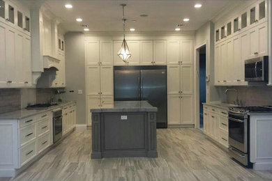 Inspiration for a large contemporary u-shaped light wood floor eat-in kitchen remodel in New York with recessed-panel cabinets, white cabinets, granite countertops, gray backsplash, ceramic backsplash, stainless steel appliances and an island