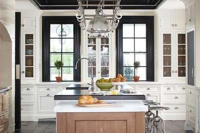 Inspiration for a large transitional u-shaped dark wood floor enclosed kitchen remodel in New York with recessed-panel cabinets, white cabinets and an island
