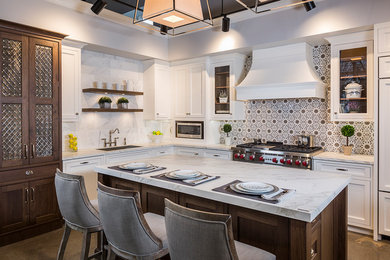 Huge transitional l-shaped concrete floor enclosed kitchen photo in Bridgeport with an undermount sink, beaded inset cabinets, white cabinets, marble countertops, multicolored backsplash, stone slab backsplash, stainless steel appliances and an island