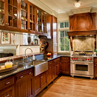 Kitchen - victorian u-shaped medium tone wood floor kitchen idea in Bridgeport with a farmhouse sink, recessed-panel cabinets, medium tone wood cabinets, stainless steel appliances and no island