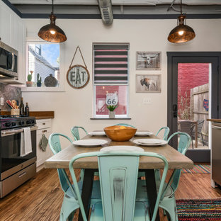 Small industrial eat-in kitchen pictures - Small urban galley dark wood floor and brown floor eat-in kitchen photo in Other with shaker cabinets, white cabinets, gray backsplash, stainless steel appliances, no island and brown countertops