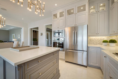 Large modern u-shaped kitchen/diner in Toronto with a submerged sink, beaded cabinets, grey cabinets, engineered stone countertops, grey splashback, ceramic splashback, stainless steel appliances, porcelain flooring, an island and beige floors.