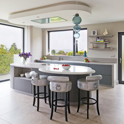 Example of a trendy galley kitchen design in Belfast with gray cabinets and an island