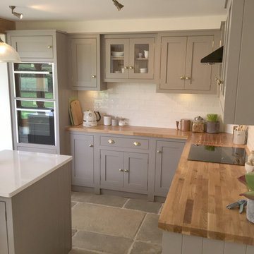 Grey country cottage with island and wooden worktops