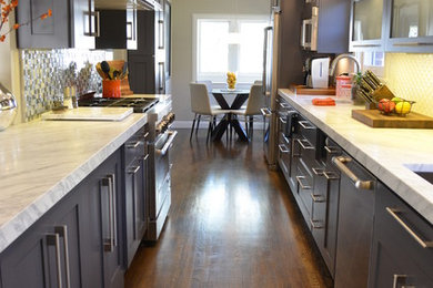 Example of a large trendy galley dark wood floor kitchen design in Sacramento with an undermount sink, shaker cabinets, gray cabinets, marble countertops, white backsplash, stainless steel appliances and no island