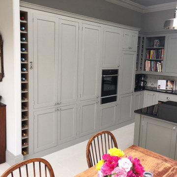 Grey hand painted kitchen with flat panel cabinets and large island