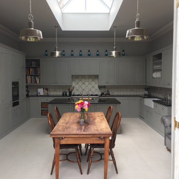 Grey hand painted kitchen with flat panel cabinets and large island