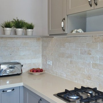 grey kitchen with brick wall