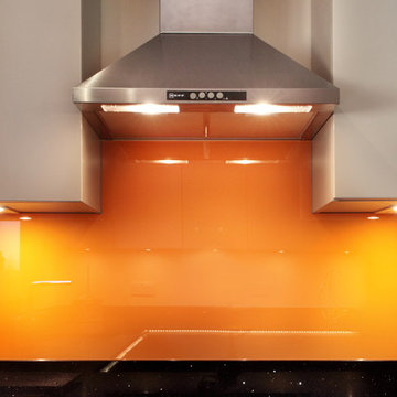 Grey kitchen with orange splash back