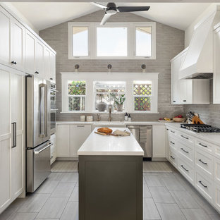 Mid-sized transitional kitchen inspiration - Example of a mid-sized transitional u-shaped porcelain tile and gray floor kitchen design in San Diego with a farmhouse sink, shaker cabinets, white cabinets, quartz countertops, gray backsplash, ceramic backsplash, stainless steel appliances, an island and white countertops