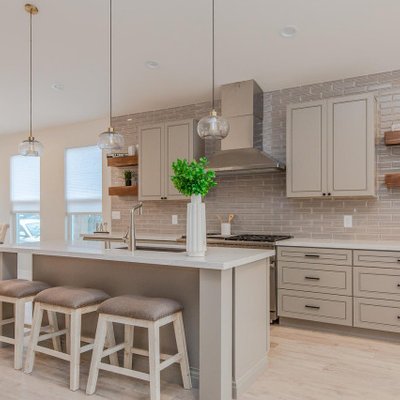 Mid-sized transitional galley beige floor eat-in kitchen photo in San Francisco with an undermount sink, raised-panel cabinets, gray cabinets, gray backsplash, subway tile backsplash, stainless steel appliances, an island and beige countertops