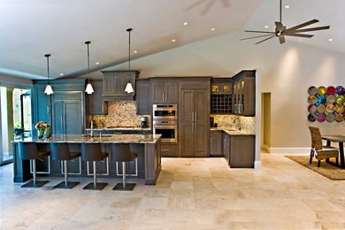 Eat-in kitchen - mid-sized contemporary l-shaped marble floor and beige floor eat-in kitchen idea in Miami with an undermount sink, shaker cabinets, brown cabinets, granite countertops, beige backsplash, glass tile backsplash, stainless steel appliances and an island