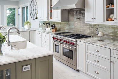 Inspiration for a large transitional l-shaped marble floor and white floor eat-in kitchen remodel in Tampa with an undermount sink, flat-panel cabinets, white cabinets, stainless steel appliances, two islands, granite countertops, green backsplash, ceramic backsplash and multicolored countertops