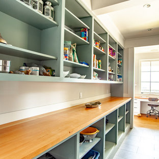 Mid-sized traditional galley kitchen pantry in Vancouver with shaker cabinets, green cabinets, wood benchtops, beige splashback, ceramic floors, grey floor and orange benchtop.