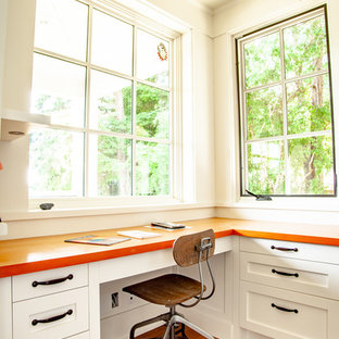 This is an example of a mid-sized traditional u-shaped eat-in kitchen in Vancouver with an undermount sink, shaker cabinets, white cabinets, blue splashback, ceramic splashback, stainless steel appliances, medium hardwood floors, with island, brown floor, wood benchtops and orange benchtop.